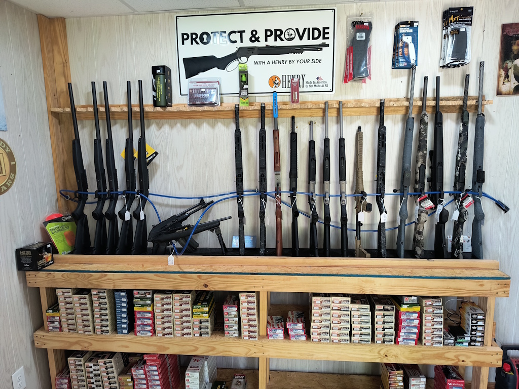 Askew Arms display rack showcasing rifles and ammunition