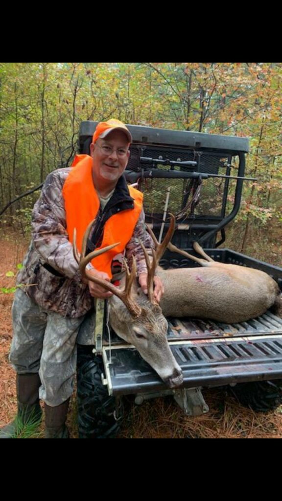 Paul Askew with a buck on his side by side