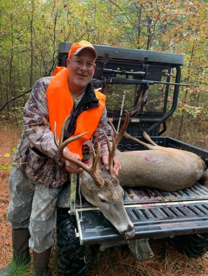 Paul Askew with a buck on his side by side
